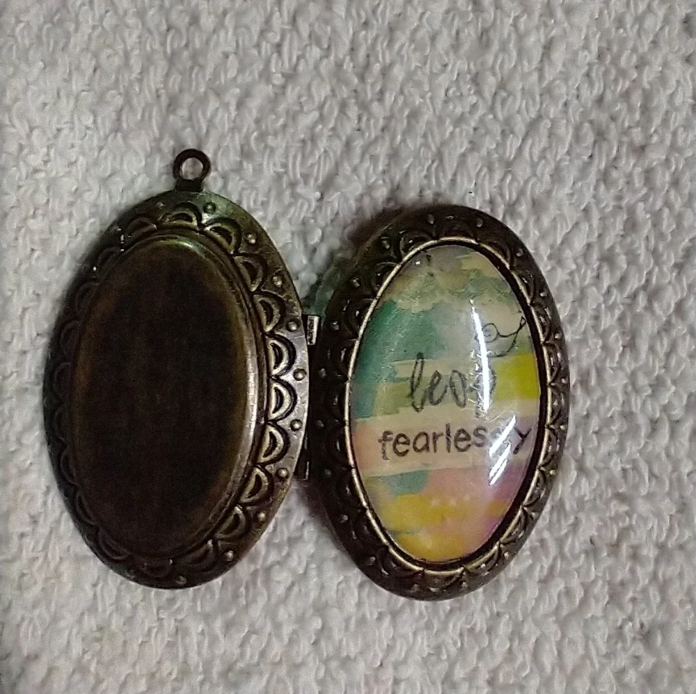 Bronze tone leap fearlessly bird locket pendant